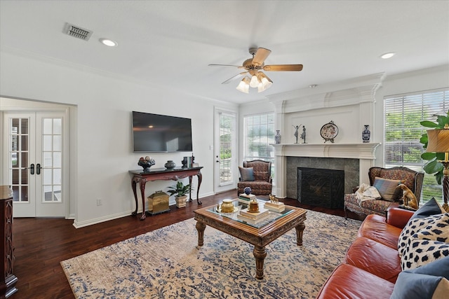 444 Avalon Ln, Coppell, TX 75019 - living area with ornamental molding, a tile fireplace, a ceiling fan, healthy amount of natural light, and dark wood-type flooring