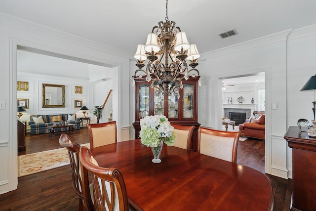 444 Avalon Ln, Coppell, TX 75019 - dining room with a chandelier, dark wood finished floors, a fireplace, and crown molding