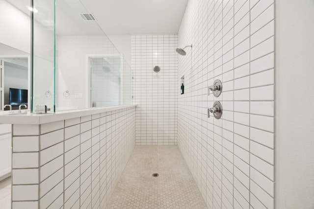 2560 Liverpool Ln, Carrollton, TX 75010 - bathroom featuring a tile shower and tile patterned floors