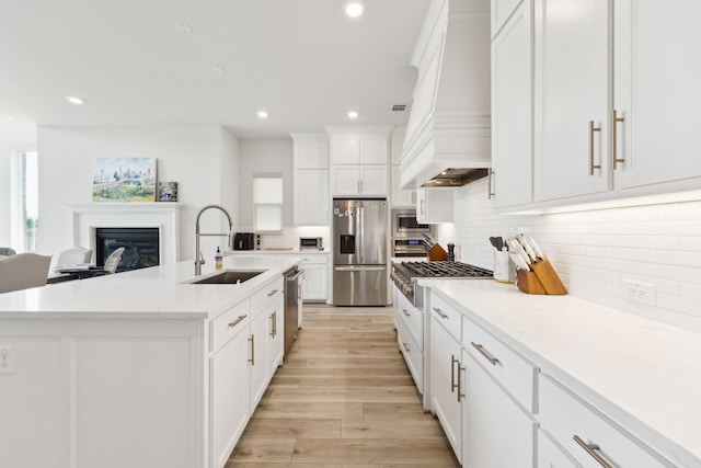 2560 Liverpool Ln, Carrollton, TX 75010 - kitchen featuring stainless steel appliances, a sink, recessed lighting, premium range hood, and white cabinetry
