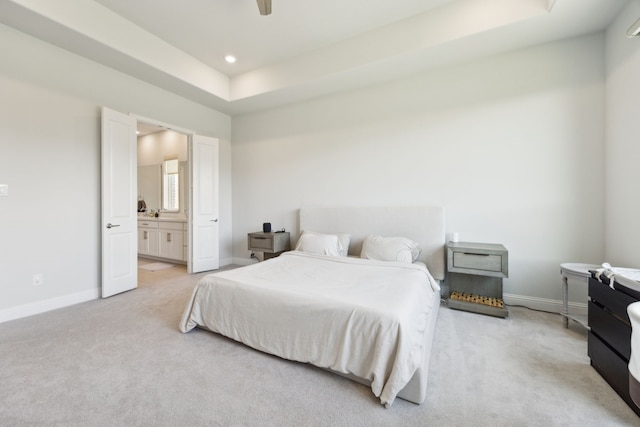 2560 Liverpool Ln, Carrollton, TX 75010 - carpeted bedroom with baseboards, a raised ceiling, ensuite bathroom, recessed lighting, and a ceiling fan