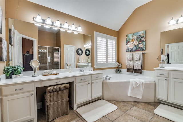 2345 Falls View Dr, Rockwall, TX 75087 - full bath featuring a stall shower, vaulted ceiling, a bath, two vanities, and tile patterned flooring