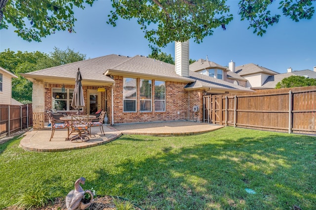 2345 Falls View Dr, Rockwall, TX 75087 - back of house featuring brick siding, a patio area, a chimney, and a shingled roof
