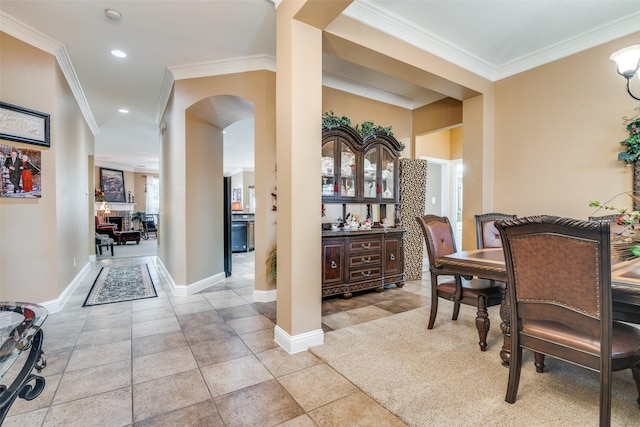2345 Falls View Dr, Rockwall, TX 75087 - dining room featuring ornamental molding, arched walkways, baseboards, recessed lighting, and light tile patterned flooring
