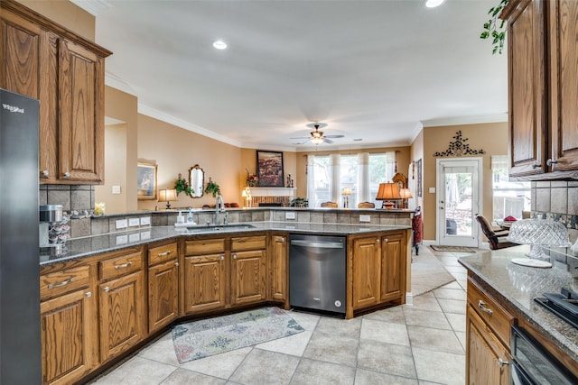 2345 Falls View Dr, Rockwall, TX 75087 - kitchen with stainless steel appliances, a sink, brown cabinets, ornamental molding, and a ceiling fan