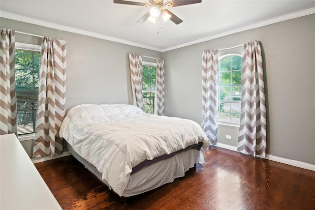 821 Columbia St, Beverly Hills, TX 76711 - bedroom featuring multiple windows, dark wood-type flooring, baseboards, crown molding, and ceiling fan