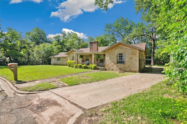 821 Columbia St, Beverly Hills, TX 76711 - ranch-style house featuring stone siding, a chimney, a front yard, and a porch