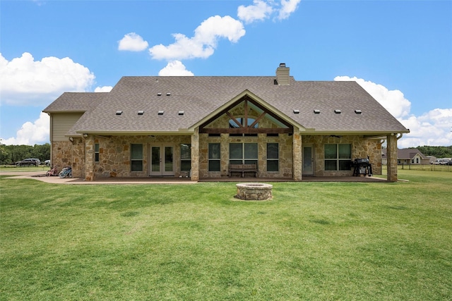 824 Lakeland Park Cir, Mart, TX 76664 - back of property featuring a fire pit, stone siding, french doors, and a yard