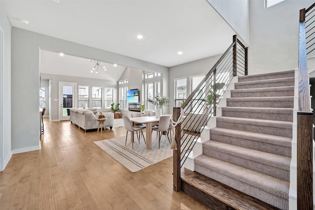 3580 Spruce Hills St, Frisco, TX 75033 - dining room with stairs, light wood finished floors, baseboards, recessed lighting, and vaulted ceiling