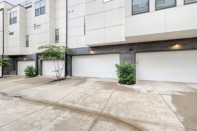 1813 Park Ave Unit 204, Dallas, TX 75215 - exterior space featuring brick siding, a garage, and driveway