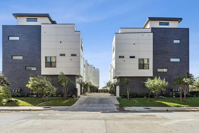 1813 Park Ave Unit 204, Dallas, TX 75215 - view of building exterior featuring concrete driveway and a garage
