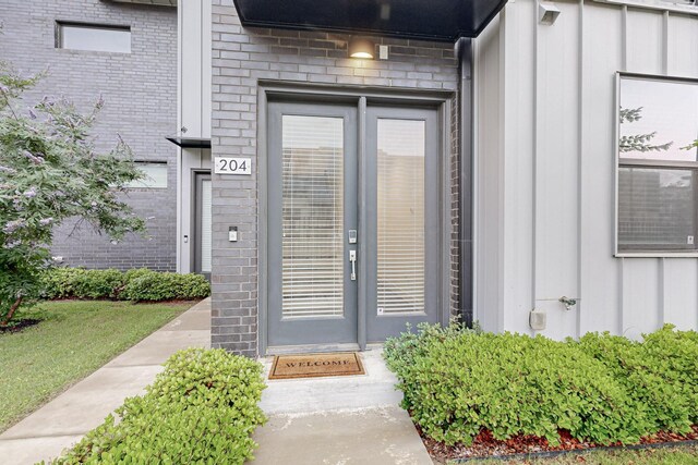 1813 Park Ave Unit 204, Dallas, TX 75215 - view of exterior entry featuring board and batten siding and brick siding