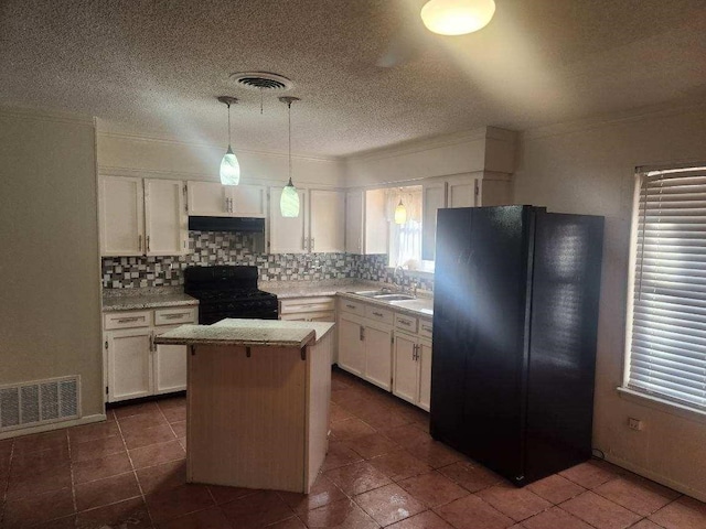 1100 8th St, Cooper, TX 75432 - kitchen with black appliances, a sink, white cabinets, light countertops, and crown molding