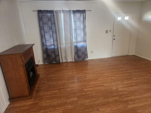 1100 8th St, Cooper, TX 75432 - unfurnished living room with wood finished floors