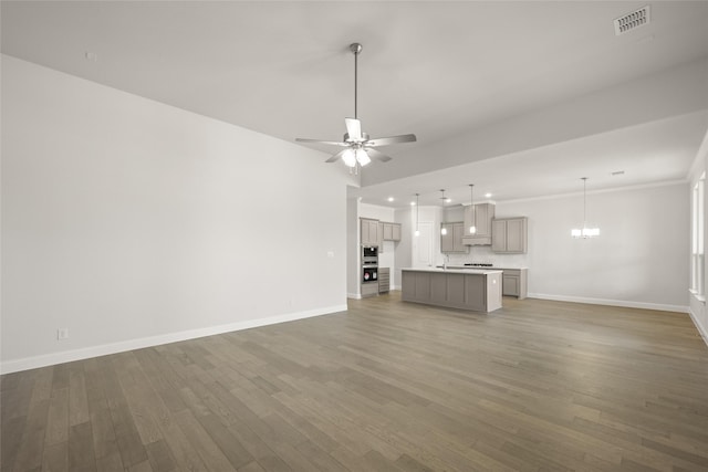 6013 Valley View Dr, Joshua, TX 76058 - unfurnished living room featuring baseboards, wood finished floors, a chandelier, a ceiling fan, and recessed lighting