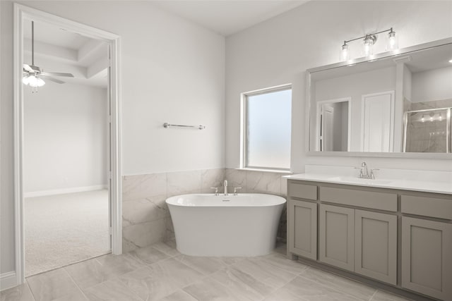 6013 Valley View Dr, Joshua, TX 76058 - full bathroom with vanity, a stall shower, a freestanding bath, a ceiling fan, and wainscoting