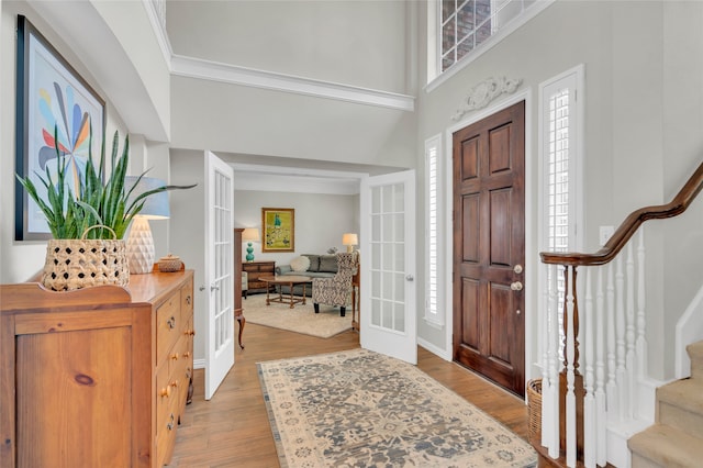 3712 Stockport Dr, Plano, TX 75025 - entrance foyer featuring french doors, stairway, light wood-type flooring, plenty of natural light, and a towering ceiling