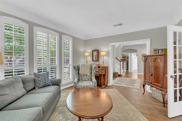 3712 Stockport Dr, Plano, TX 75025 - living area featuring stairs, wood finished floors, crown molding, and arched walkways