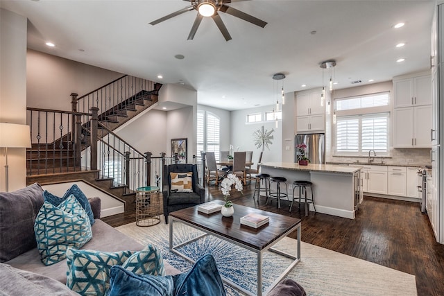 731 Spanish Oaks Pl, Dallas, TX 75204 - living room with dark wood-style flooring, a ceiling fan, stairs, and recessed lighting