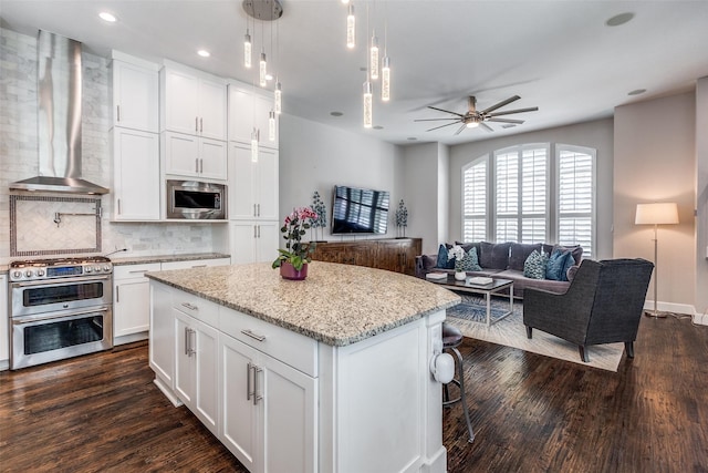 731 Spanish Oaks Pl, Dallas, TX 75204 - kitchen with appliances with stainless steel finishes, wall chimney exhaust hood, open floor plan, backsplash, and dark wood finished floors