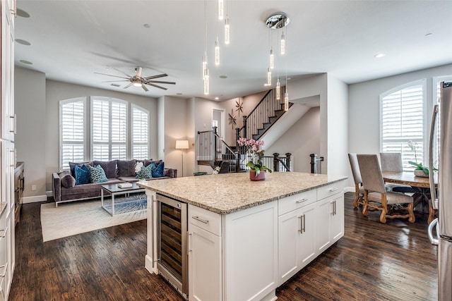 731 Spanish Oaks Pl, Dallas, TX 75204 - kitchen featuring wine cooler, dark wood-style flooring, open floor plan, a center island, and recessed lighting
