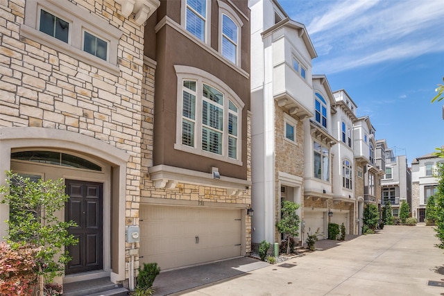 731 Spanish Oaks Pl, Dallas, TX 75204 - entrance to property with stone siding, a garage, a residential view, stucco siding, and driveway