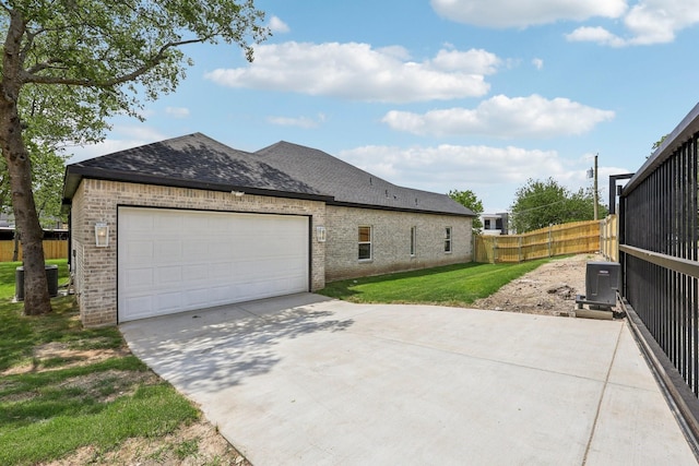 6002 Verde Way, Dallas, TX 75211 - view of home's exterior featuring brick siding, driveway, an attached garage, roof with shingles, and central AC unit