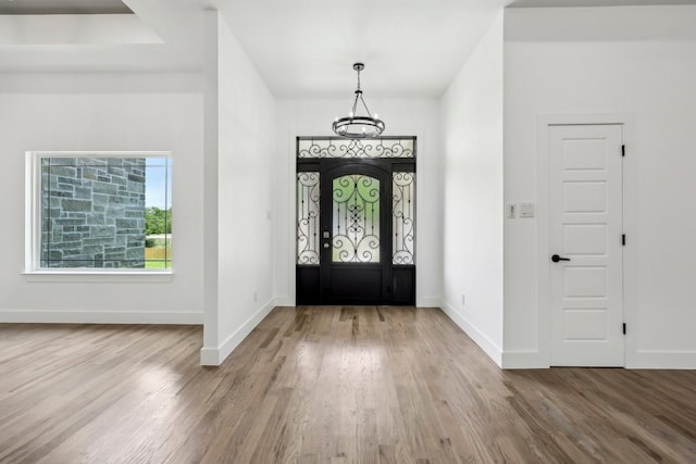 6002 Verde Way, Dallas, TX 75211 - foyer with a chandelier, wood finished floors, and baseboards