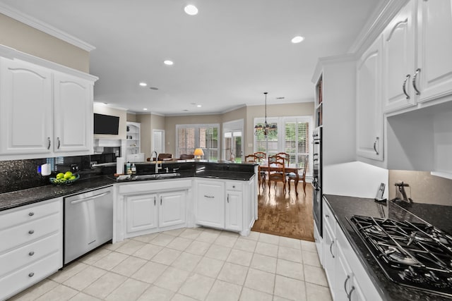 704 Longford Dr, Southlake, TX 76092 - kitchen with stainless steel appliances, a sink, ornamental molding, white cabinets, and a peninsula