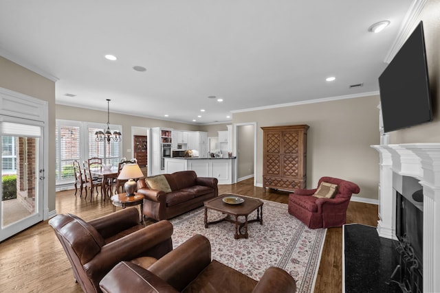 704 Longford Dr, Southlake, TX 76092 - living area featuring a chandelier, wood finished floors, recessed lighting, ornamental molding, and a fireplace