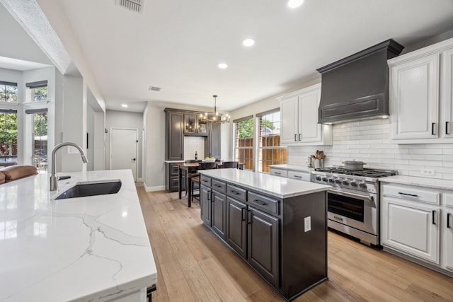 406 Misty Meadow Dr, Allen, TX 75013 - kitchen with high end stainless steel range oven, a sink, recessed lighting, white cabinets, and a center island