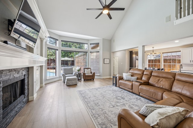 406 Misty Meadow Dr, Allen, TX 75013 - living room with high vaulted ceiling, a chandelier, a ceiling fan, a stone fireplace, and plenty of natural light