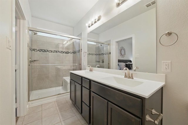 2101 Chebi Ln, Denton, TX 76209 - bathroom featuring tile patterned flooring, double vanity, a stall shower, and ensuite bath
