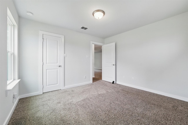 2101 Chebi Ln, Denton, TX 76209 - unfurnished bedroom featuring carpet flooring and multiple windows