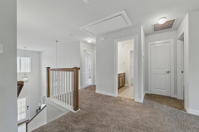 2101 Chebi Ln, Denton, TX 76209 - hallway featuring attic access, light carpet, and an upstairs landing