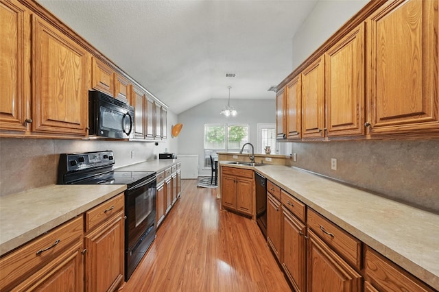 10700 Irish Glen Trl, Haslet, TX 76052 - kitchen with black appliances, brown cabinetry, light wood-style floors, a sink, and vaulted ceiling