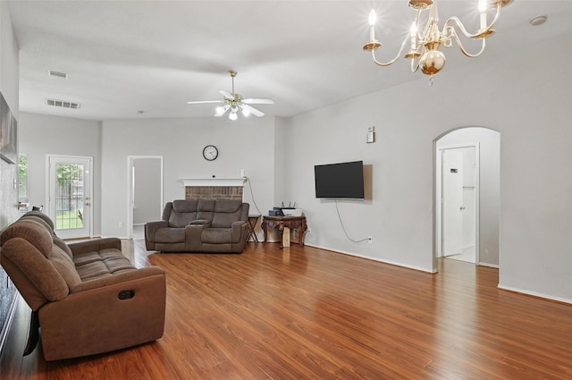 10700 Irish Glen Trl, Haslet, TX 76052 - living area featuring arched walkways, wood finished floors, ceiling fan, a chandelier, and a fireplace