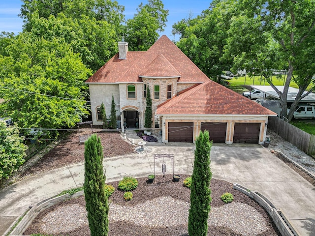 5716 Wall Ave, Haltom City, TX 76117 - french country style house with a chimney, stone siding, a garage, driveway, and roof with shingles