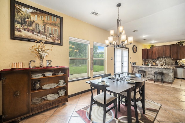 5716 Wall Ave, Haltom City, TX 76117 - dining room featuring light tile patterned flooring and a chandelier
