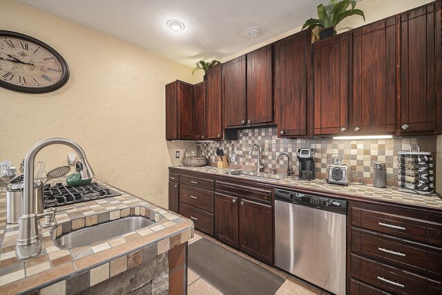 5716 Wall Ave, Haltom City, TX 76117 - kitchen featuring stainless steel dishwasher, tile countertops, a sink, tasteful backsplash, and a textured wall