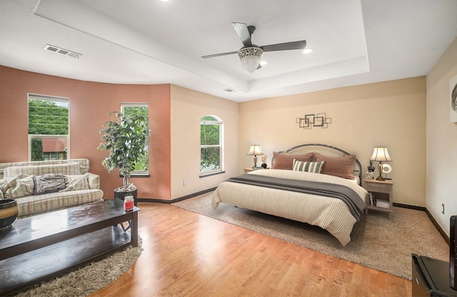 5716 Wall Ave, Haltom City, TX 76117 - bedroom with a raised ceiling, baseboards, light wood finished floors, recessed lighting, and ceiling fan