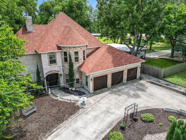 5716 Wall Ave, Haltom City, TX 76117 - view of front of property featuring stone siding, a chimney, an attached garage, roof with shingles, and driveway