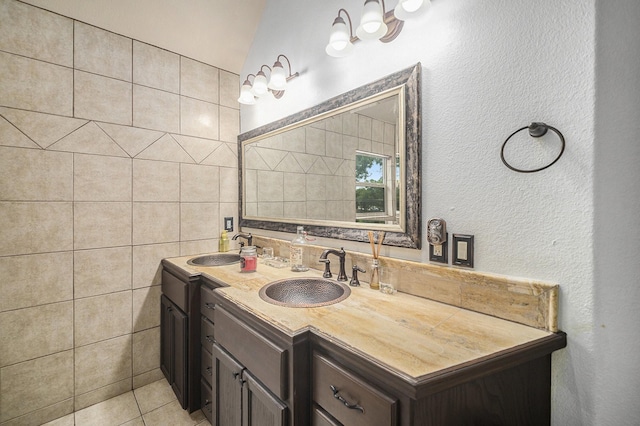 5716 Wall Ave, Haltom City, TX 76117 - full bathroom featuring double vanity, tile patterned flooring, and tile walls