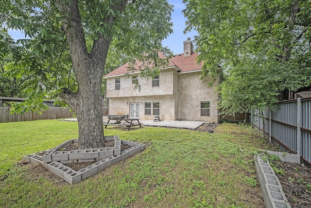 5716 Wall Ave, Haltom City, TX 76117 - back of property featuring stucco siding, a chimney, a patio, and a garden