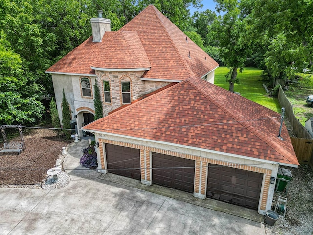 5716 Wall Ave, Haltom City, TX 76117 - view of front of home featuring a chimney, driveway, a shingled roof, a garage, and stone siding