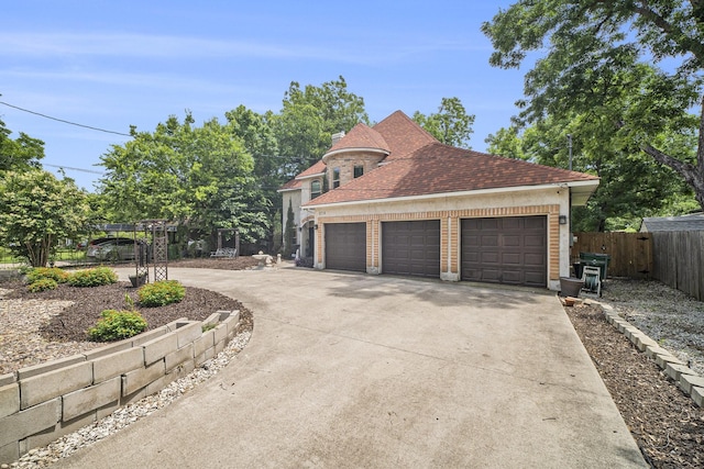 5716 Wall Ave, Haltom City, TX 76117 - view of home's exterior with a garage, roof with shingles, brick siding, and driveway