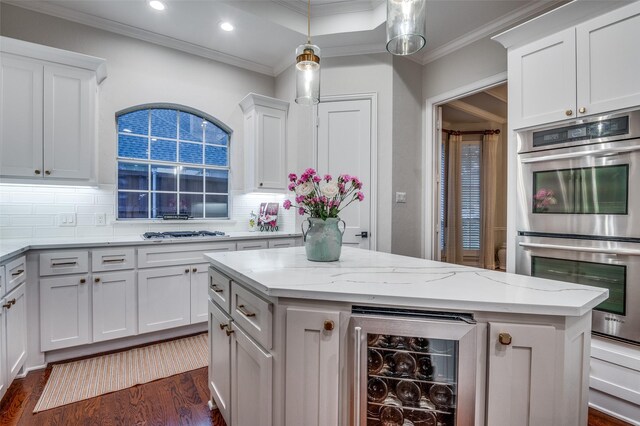 5932 Royal Palm Dr, Plano, TX 75093 - kitchen featuring beverage cooler, appliances with stainless steel finishes, crown molding, decorative backsplash, and white cabinets
