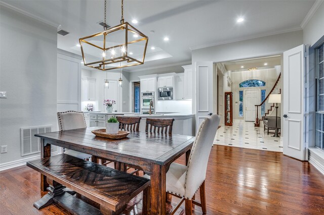 5932 Royal Palm Dr, Plano, TX 75093 - dining room featuring a chandelier, wood finished floors, crown molding, recessed lighting, and stairway