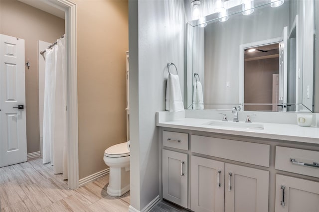 5932 Royal Palm Dr, Plano, TX 75093 - bathroom featuring toilet, vanity, baseboards, and a shower with shower curtain