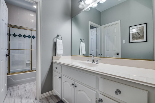 5932 Royal Palm Dr, Plano, TX 75093 - full bathroom featuring vanity, shower / bath combination with glass door, and baseboards